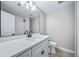 This bathroom features a white vanity with a vessel sink, matte black fixtures, and a large mirror at 3000 S Jackson St, Denver, CO 80210