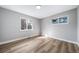 A bedroom with wood flooring, gray walls, and two windows for natural light at 3000 S Jackson St, Denver, CO 80210