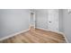 Neutral bedroom with wood floors, white walls, and a white door at 3000 S Jackson St, Denver, CO 80210