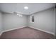 Cozy bedroom with neutral colors and natural light from basement windows at 3000 S Jackson St, Denver, CO 80210
