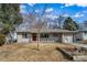 Charming single-story home featuring a well-maintained lawn, inviting entrance, and an attached one car garage at 3000 S Jackson St, Denver, CO 80210