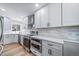 A modern kitchen boasts white cabinets, stainless steel appliances, and quartz countertops at 3000 S Jackson St, Denver, CO 80210