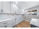 Kitchen area featuring long countertop, ample cabinet storage, with subway tile backsplash, and a window view at 3000 S Jackson St, Denver, CO 80210