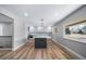 Bright and airy kitchen featuring a large island with seating, modern appliances, and stylish finishes at 3000 S Jackson St, Denver, CO 80210