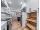 A bright kitchen featuring stainless steel appliances, white cabinetry and a dark island at 3000 S Jackson St, Denver, CO 80210