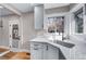 A kitchen features white cabinets, quartz countertops and stainless steel appliances at 3000 S Jackson St, Denver, CO 80210