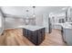 A kitchen with stainless steel appliances, a large center island and wood flooring at 3000 S Jackson St, Denver, CO 80210