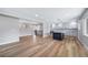 Open floor plan showcasing a modern kitchen with a spacious island, stainless appliances, and stylish lighting at 3000 S Jackson St, Denver, CO 80210