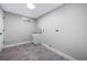 Well-lit laundry room with new flooring and a utility sink at 3000 S Jackson St, Denver, CO 80210