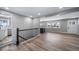 A spacious open-concept living room with wood flooring, stairs and lots of natural light at 3000 S Jackson St, Denver, CO 80210