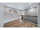 Upstairs space with wood flooring and a metal railing and door to outside deck at 3000 S Jackson St, Denver, CO 80210