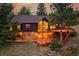 A captivating backyard featuring a spacious deck, mature trees, and exterior home view at 21849 Cabrini Blvd, Golden, CO 80401