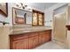 Bathroom featuring a vanity with granite counters, stained glass window, and tiled shower at 21849 Cabrini Blvd, Golden, CO 80401
