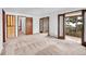 Spacious bedroom with multiple doors leading to a bathroom, sunroom, and other rooms at 21849 Cabrini Blvd, Golden, CO 80401