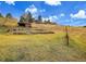 Rustic buildings nestled in a picturesque hillside setting at 21849 Cabrini Blvd, Golden, CO 80401