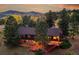 Stunning exterior of home at twilight, featuring large deck, mature trees, and a beautiful yard at 21849 Cabrini Blvd, Golden, CO 80401