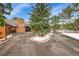 The exterior of the house features a stone chimney, brick and wood paneling, and a circular driveway at 21849 Cabrini Blvd, Golden, CO 80401