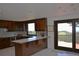 Bright kitchen with stainless steel appliances, a large island, and access to the outdoor deck at 21849 Cabrini Blvd, Golden, CO 80401