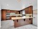 Well-lit kitchen featuring updated appliances, wood cabinetry, and an island with bar seating at 21849 Cabrini Blvd, Golden, CO 80401