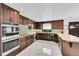 Modern kitchen with stainless steel appliances, tile backsplash, and ample counter space at 21849 Cabrini Blvd, Golden, CO 80401