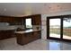 Spacious kitchen with granite counters, island, tile backsplash, and sliding door to deck at 21849 Cabrini Blvd, Golden, CO 80401