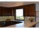 Spacious kitchen featuring classic cabinetry, a breakfast bar, and a picturesque view at 21849 Cabrini Blvd, Golden, CO 80401