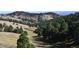 Lush landscape with rolling hills and mature trees at 21849 Cabrini Blvd, Golden, CO 80401