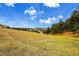 Expansive field with rolling hills and mature trees at 21849 Cabrini Blvd, Golden, CO 80401