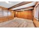 The living room features wooden walls and beams, offering a rustic and inviting ambiance at 21849 Cabrini Blvd, Golden, CO 80401