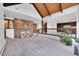 Spacious living room with a stone fireplace, vaulted ceiling, and open access to the kitchen at 21849 Cabrini Blvd, Golden, CO 80401