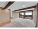 Basement with a brick accent, wooden beams, and sliding doors to a deck with a scenic view at 21849 Cabrini Blvd, Golden, CO 80401