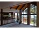 Bright living room featuring vaulted wood ceilings, exposed brick, and a wall of windows with a view at 21849 Cabrini Blvd, Golden, CO 80401