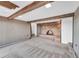 Cozy living room featuring a brick fireplace, wooden beams, and comfortable carpeting at 21849 Cabrini Blvd, Golden, CO 80401