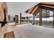 An open-concept living room featuring vaulted wood ceilings, stone accents, and a large view window at 21849 Cabrini Blvd, Golden, CO 80401