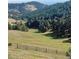 Picturesque rolling hillside mountain property with fencing at 21849 Cabrini Blvd, Golden, CO 80401