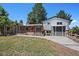 Backyard featuring deck, lawn, detached garage, and mature trees at 9350 Raleigh Ct, Westminster, CO 80031