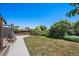 Wide backyard featuring a lush lawn, landscaping, and partial view of the home at 9350 Raleigh Ct, Westminster, CO 80031