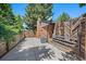 Fenced backyard featuring an air conditioning unit and exterior brick chimney at 9350 Raleigh Ct, Westminster, CO 80031
