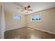 Bright bedroom with hardwood floors, ceiling fan, and two windows at 9350 Raleigh Ct, Westminster, CO 80031