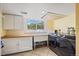 Laundry room features a modern washer and dryer, with ample cabinet space at 9350 Raleigh Ct, Westminster, CO 80031
