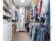 Large walk-in closet with custom shelving, drawers, and hanging racks for optimal storage at 15483 W 51St Pl, Golden, CO 80403