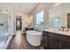 Bathroom featuring a freestanding tub, double vanity, and a glass-enclosed shower at 574 Agoseris Way, Castle Rock, CO 80104