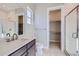 Well-lit bathroom with a glass shower, modern vanity, and tile flooring at 574 Agoseris Way, Castle Rock, CO 80104