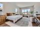 Bright bedroom featuring large windows, natural light, and a comfortable seating area at 574 Agoseris Way, Castle Rock, CO 80104