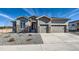 Beautiful two-story home with a three car garage, stone accents, and a well manicured front yard at 574 Agoseris Way, Castle Rock, CO 80104