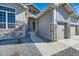 Stunning home exterior showcasing stone accents, a covered entry, and a three car garage at 574 Agoseris Way, Castle Rock, CO 80104