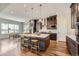 Spacious kitchen features stainless appliances, dark wood cabinetry, and a large center island with bar seating at 574 Agoseris Way, Castle Rock, CO 80104