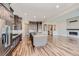 Open-concept kitchen with a central island, stainless steel appliances, and hardwood flooring at 574 Agoseris Way, Castle Rock, CO 80104