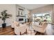 Bright living room featuring hardwood floors, a stone fireplace, and sliding glass doors to the backyard at 574 Agoseris Way, Castle Rock, CO 80104