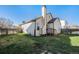 Well-maintained backyard with green grass, wood fence, and chimney at 20451 Kelly Pl, Denver, CO 80249